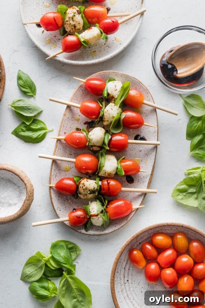 Caprese Skewers with Balsamic Glaze 3 Small oval platter filled with Caprese skewers.