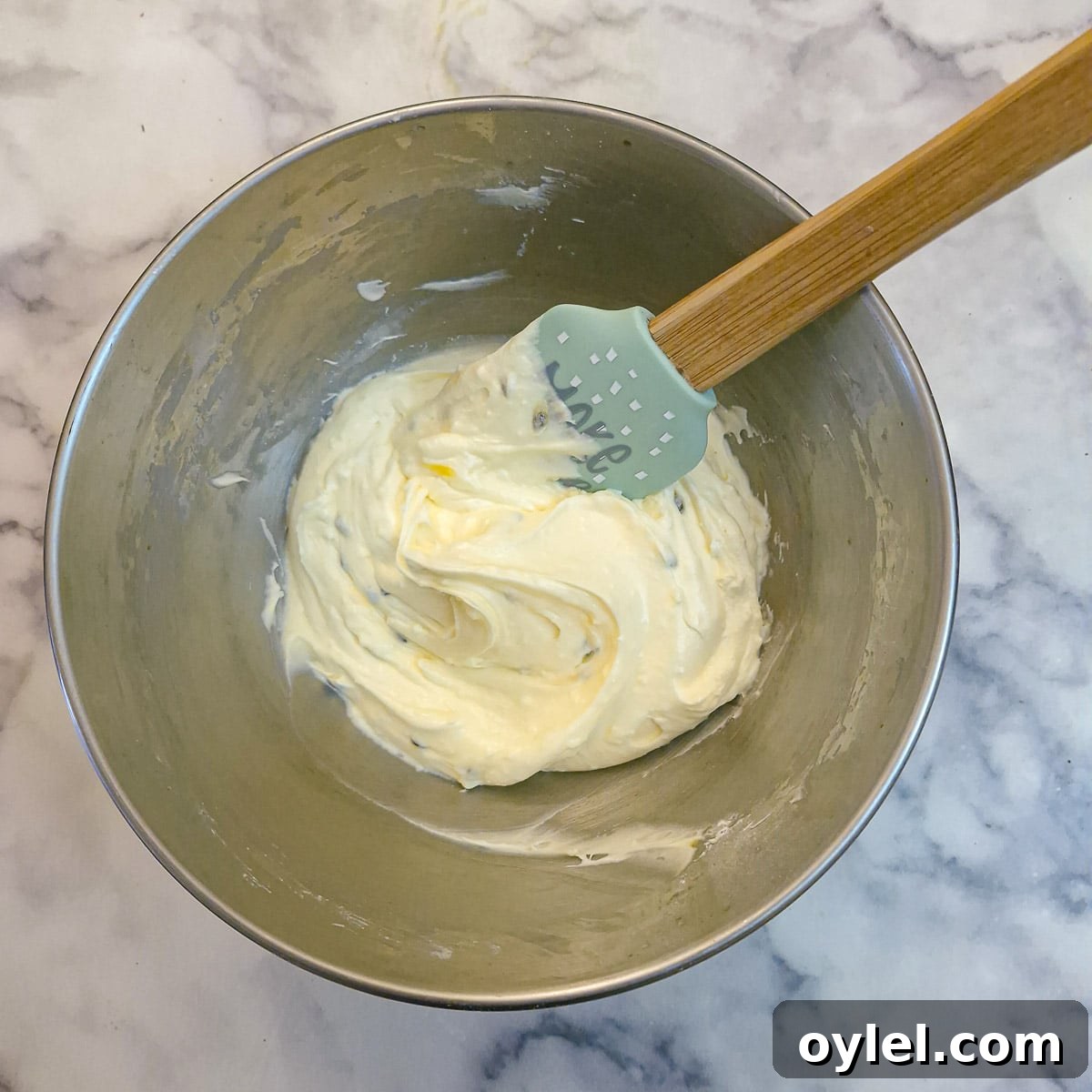 Granadilla pulp stirred into the frosting.
