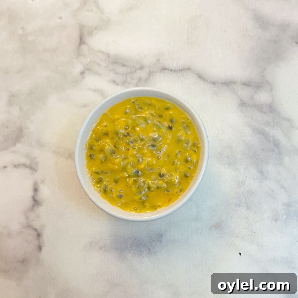 Granadilla pulp in a small white bowl.