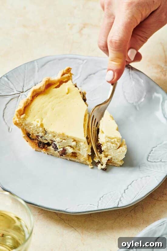 Cutting a slice of ricotta pie with fork