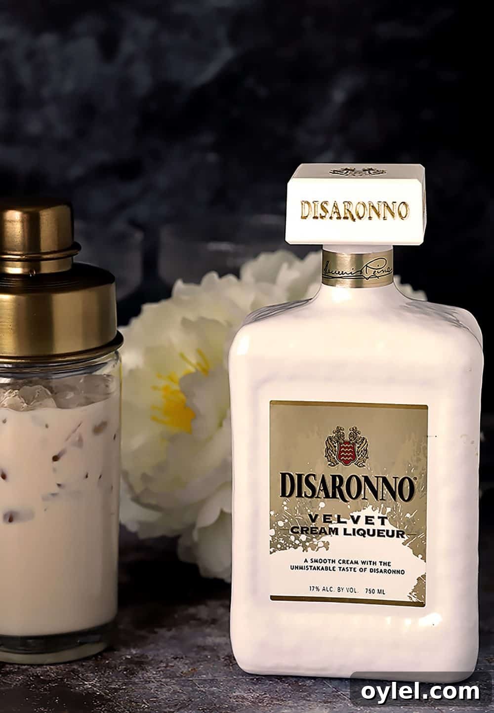 Pouring Disaronno Velvet into a cocktail shaker