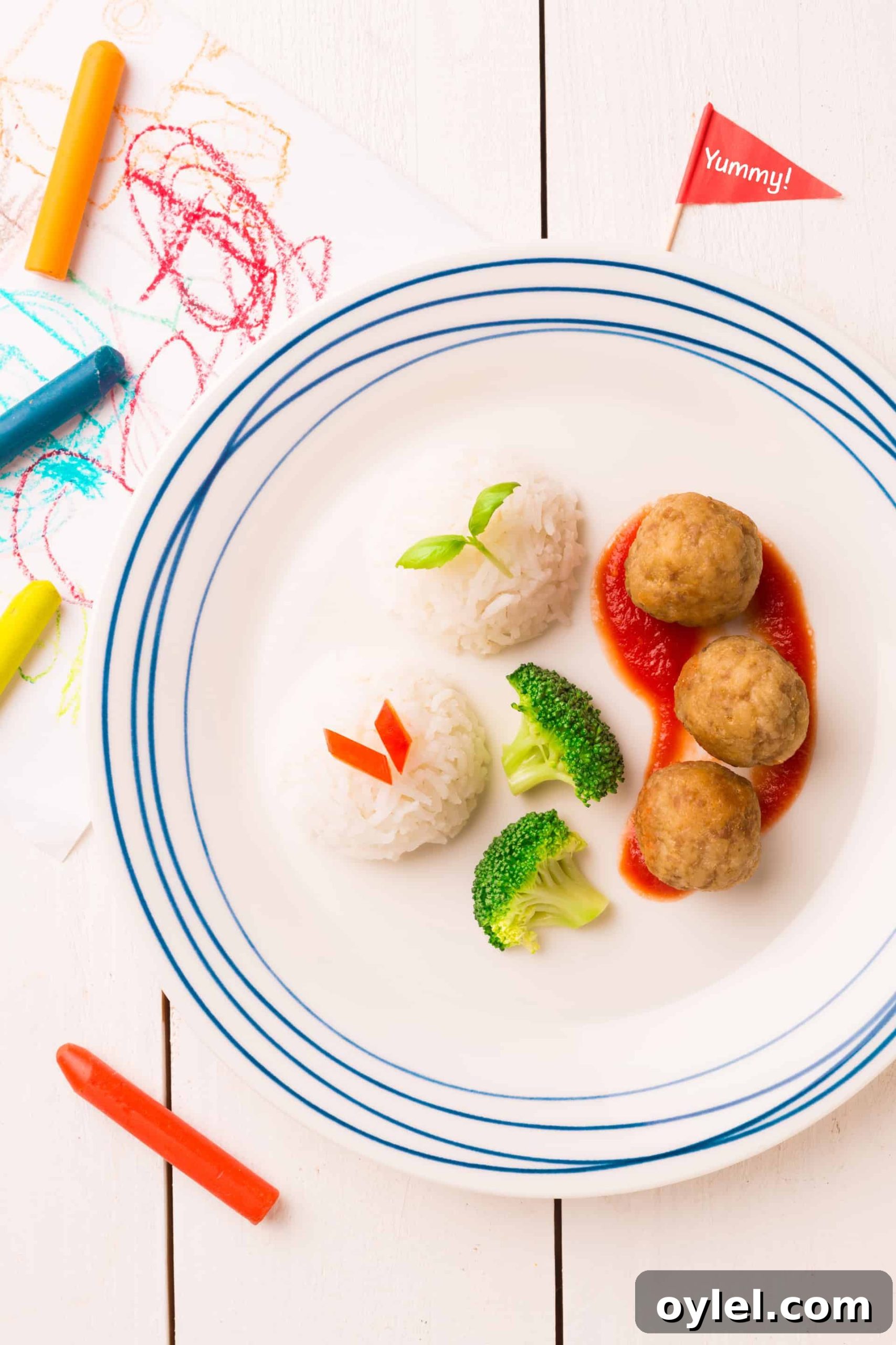 kids plate with meatballs, rice, and broccoli