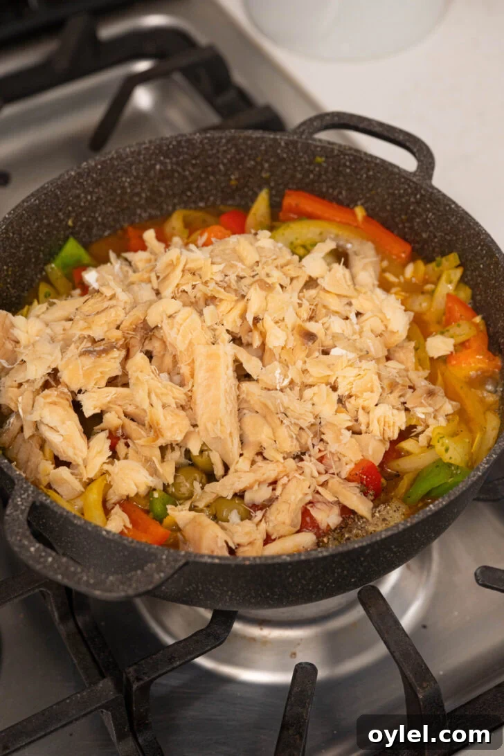 Authentic Bacalao Guisado: Stewed Salt Cod Recipe 4 A pot with salted codfish and veggies.