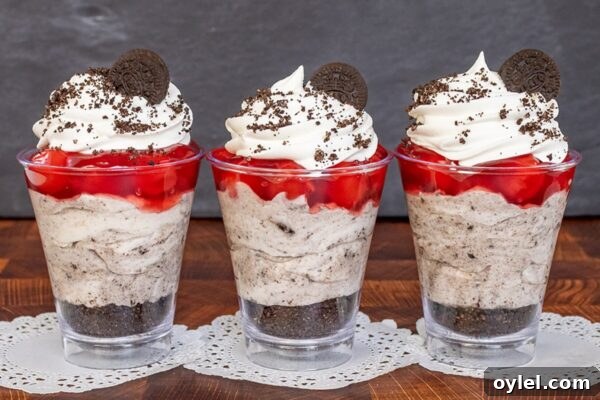 Cherry Cookies and Cream Cheesecake Parfaits layered in glasses