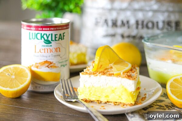 Lemon Coconut Cream Cheese layered dessert topped with whipped cream