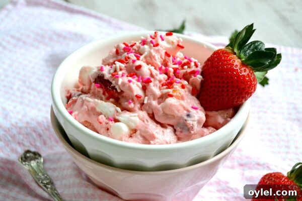 Strawberry Shortcake Fluff in a bowl with fresh strawberries