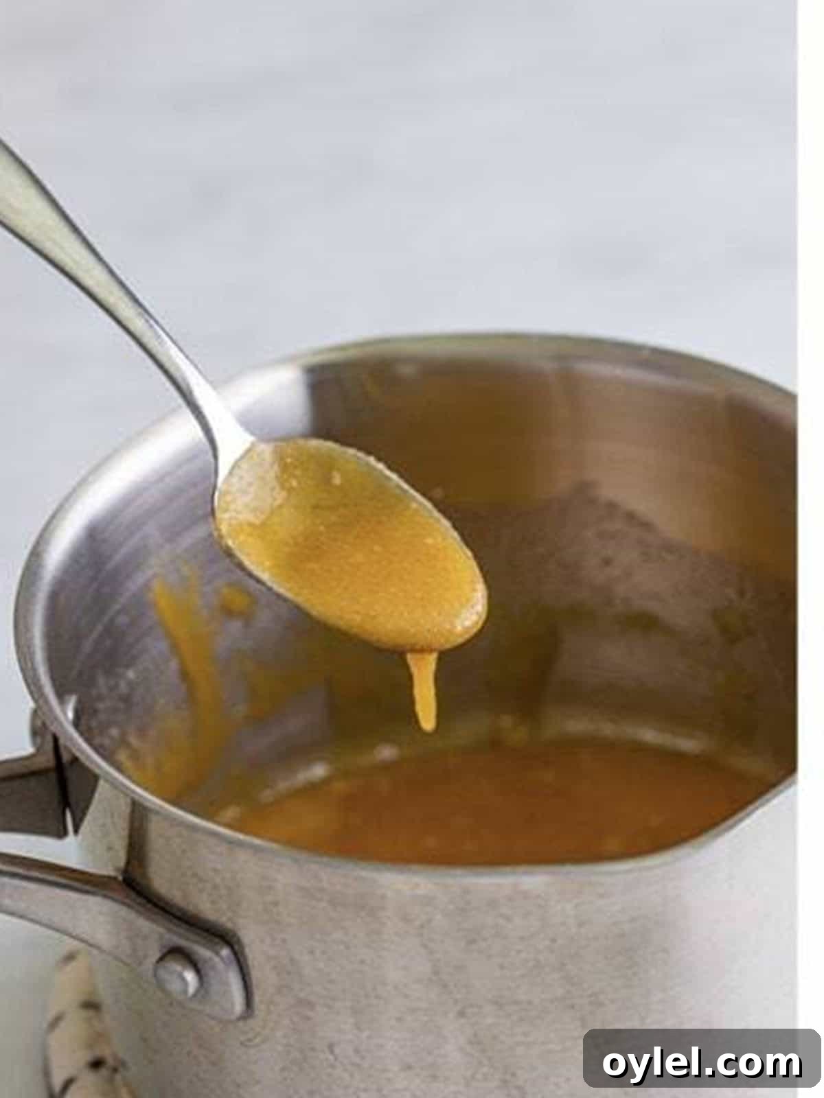 Melting butter and brown sugar into a sauce for Pineapple Upside Down Cupcakes.