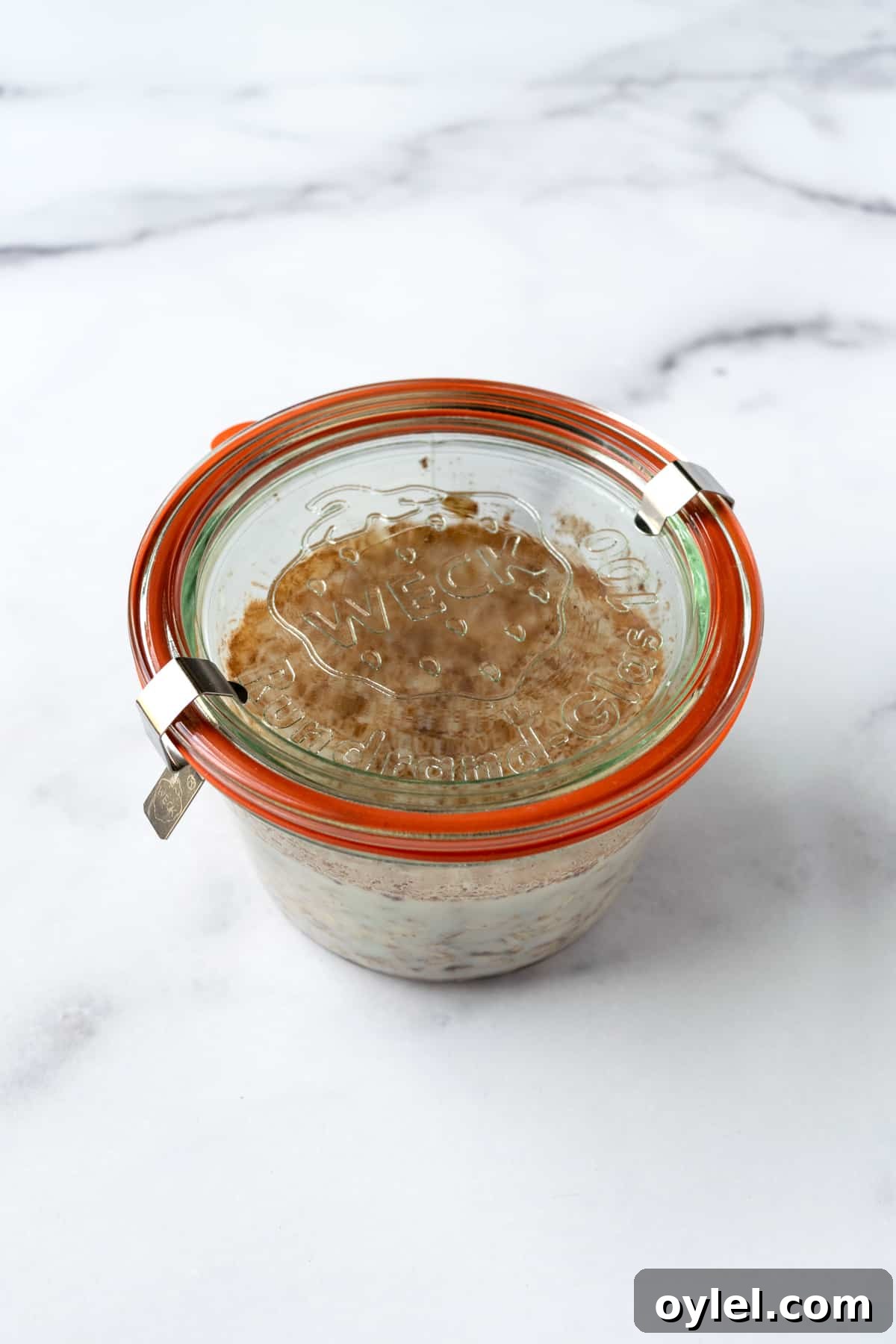 Creamy Raspberry Overnight Oats Recipe 5 A resealable jar with overnight oats.
