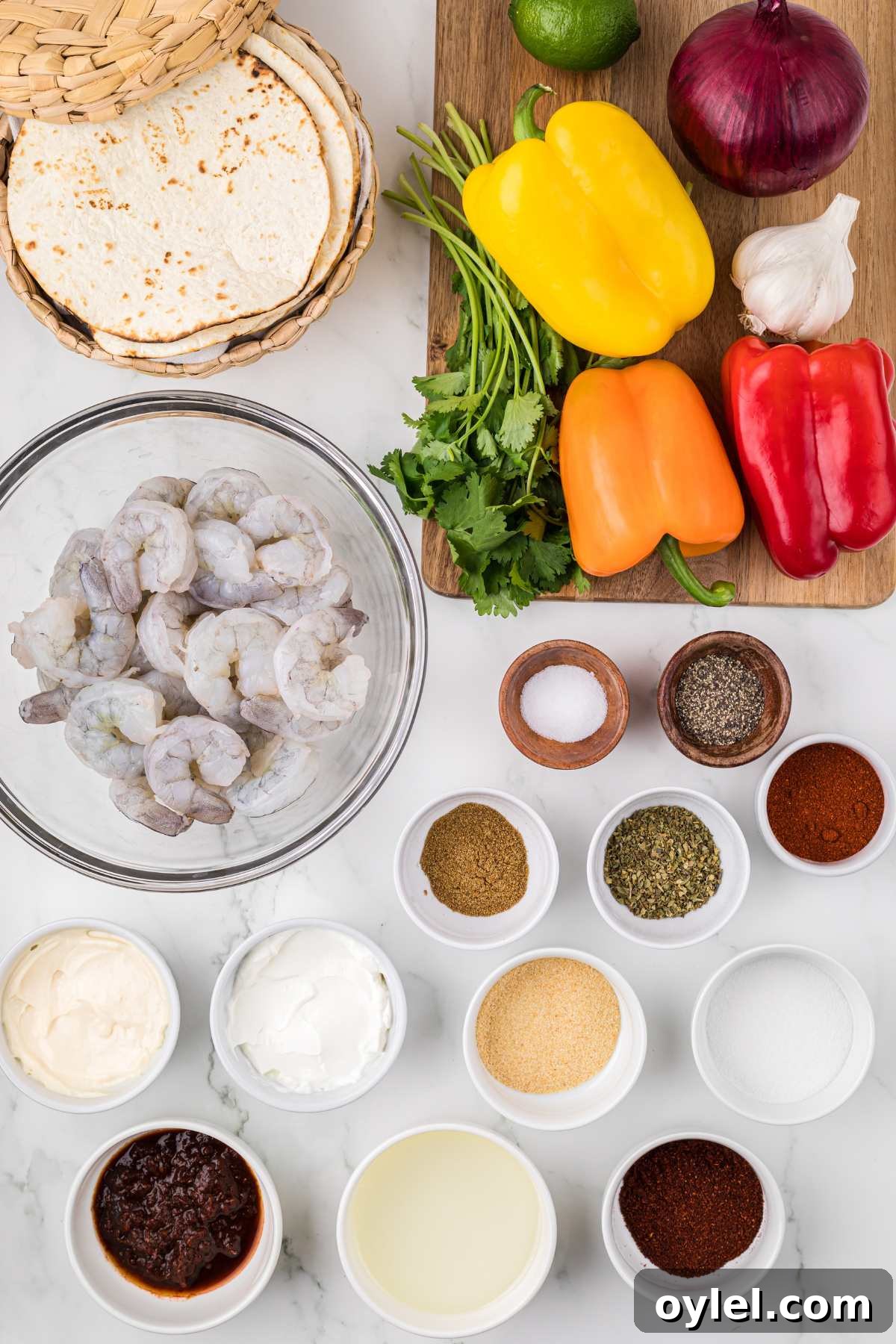 ingredients measured out in bowls and veggies on wooden board.