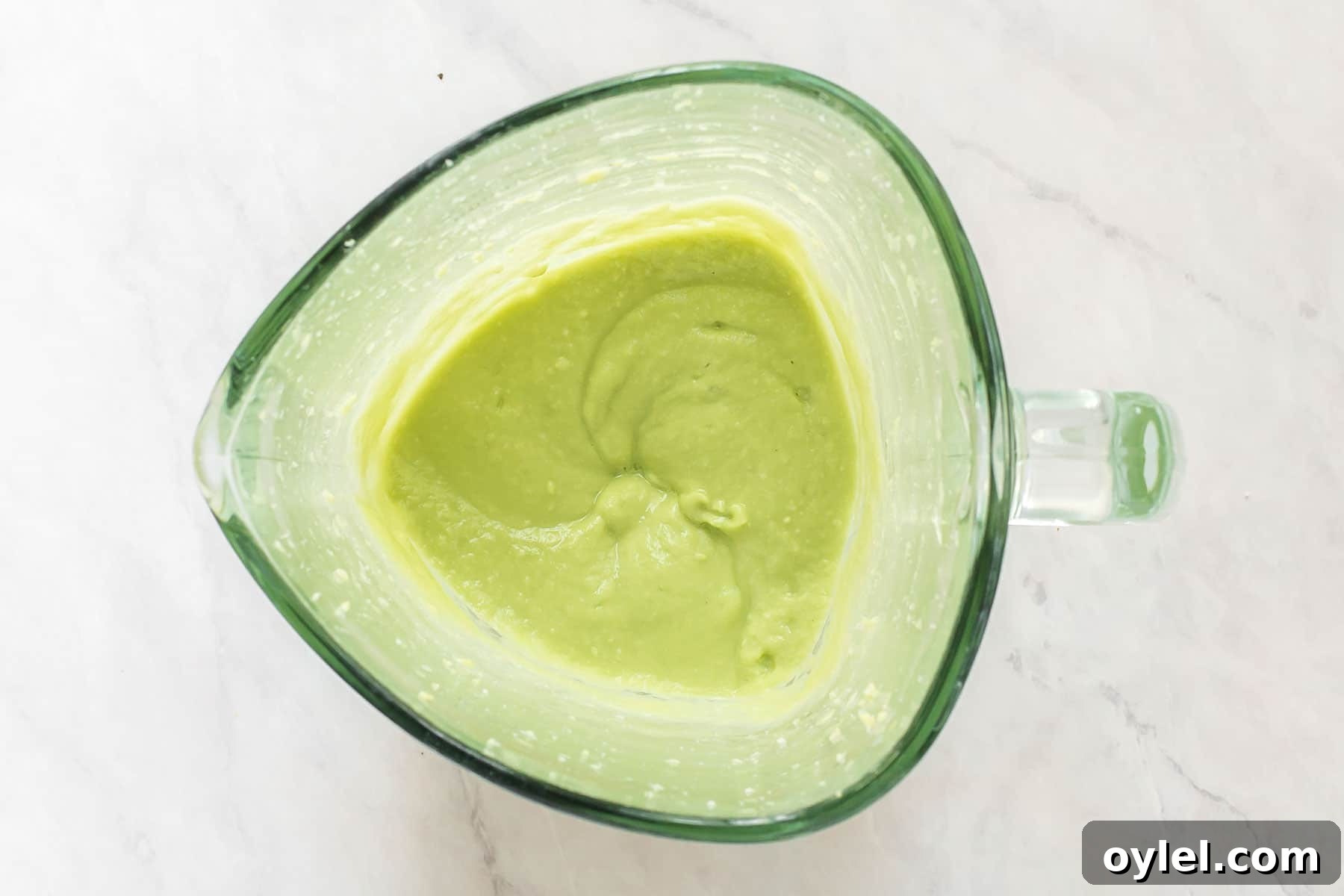 Smooth avocado sauce in blender.