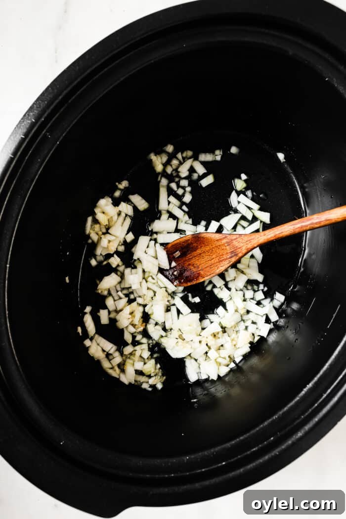 Onions, garlic, and orange juice in a slow cooker. 