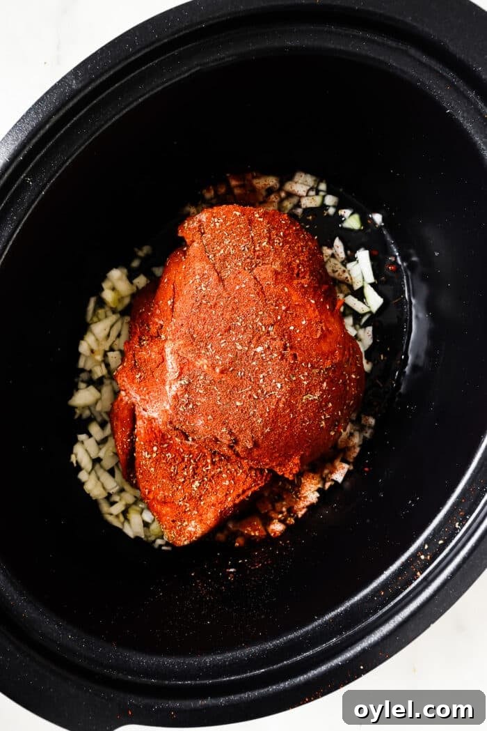 Seasoned pork shoulder in the slow cooker. 