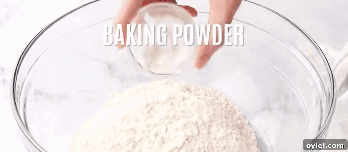Combining the dry ingredients to make the biscuits in a glass bowl.