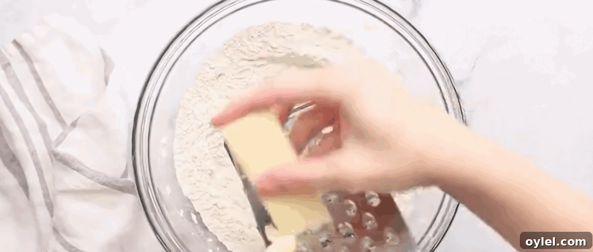 Grating the frozen butter into the dry ingredients.