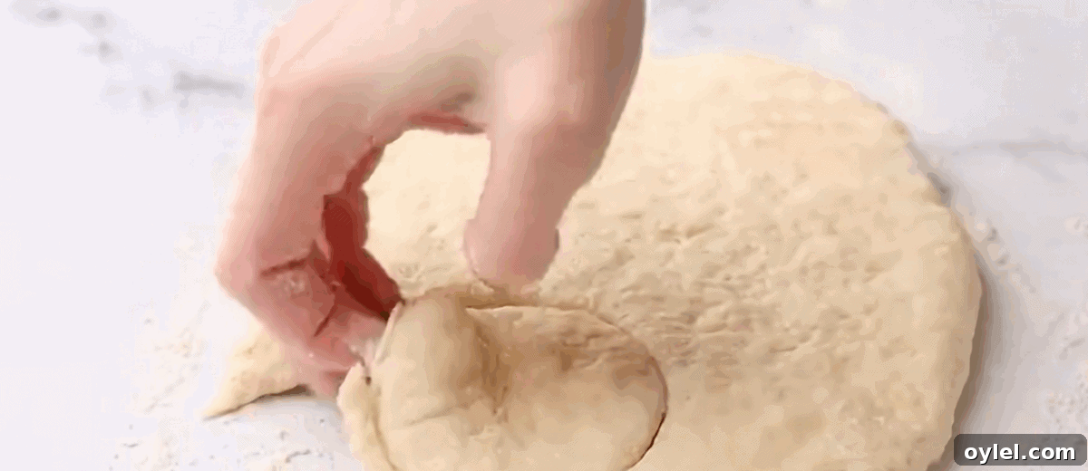 Cutting biscuit sized pieces of dough.