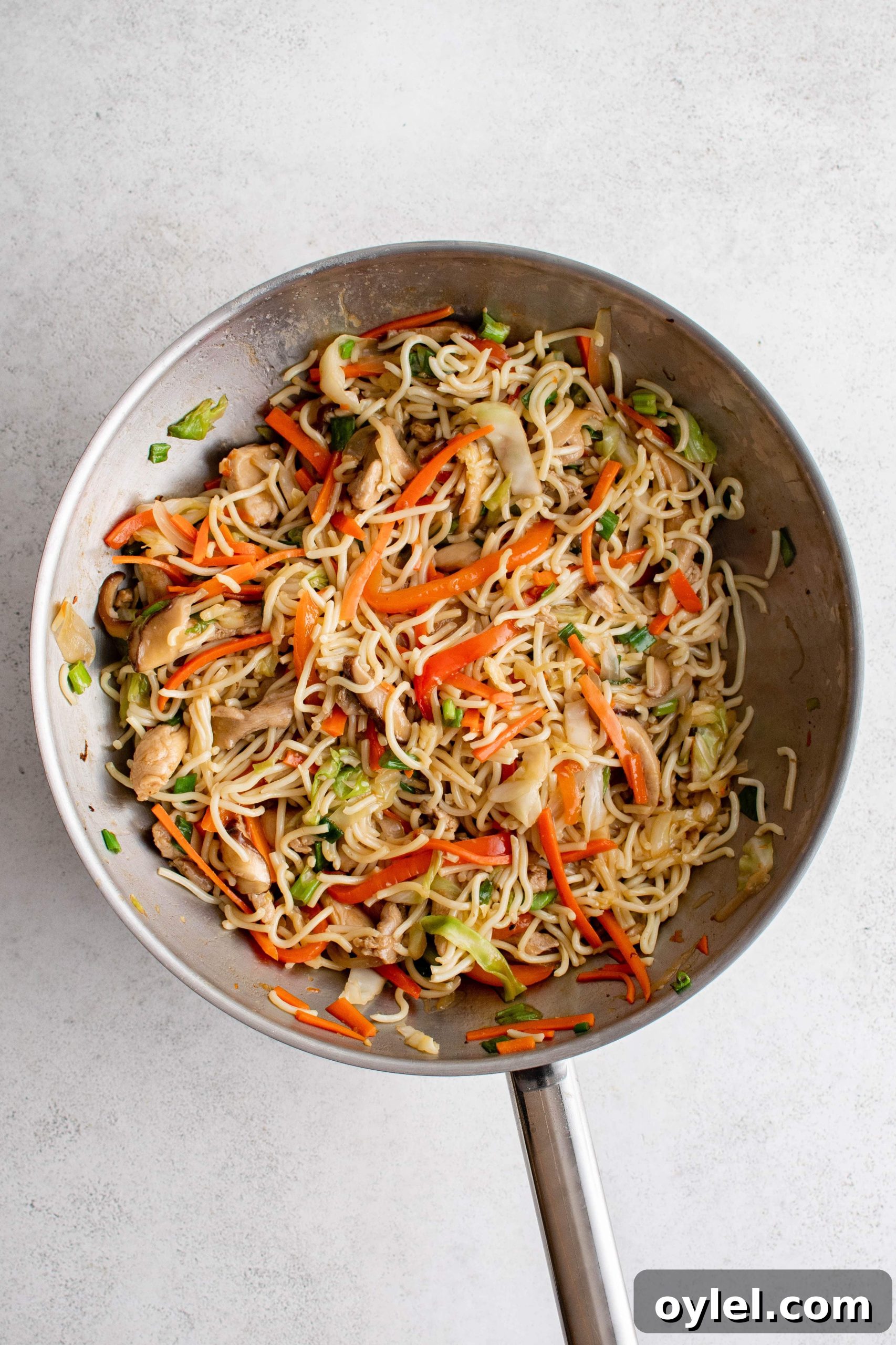 Fully cooked yakisoba noodles cooked and in a large wok.