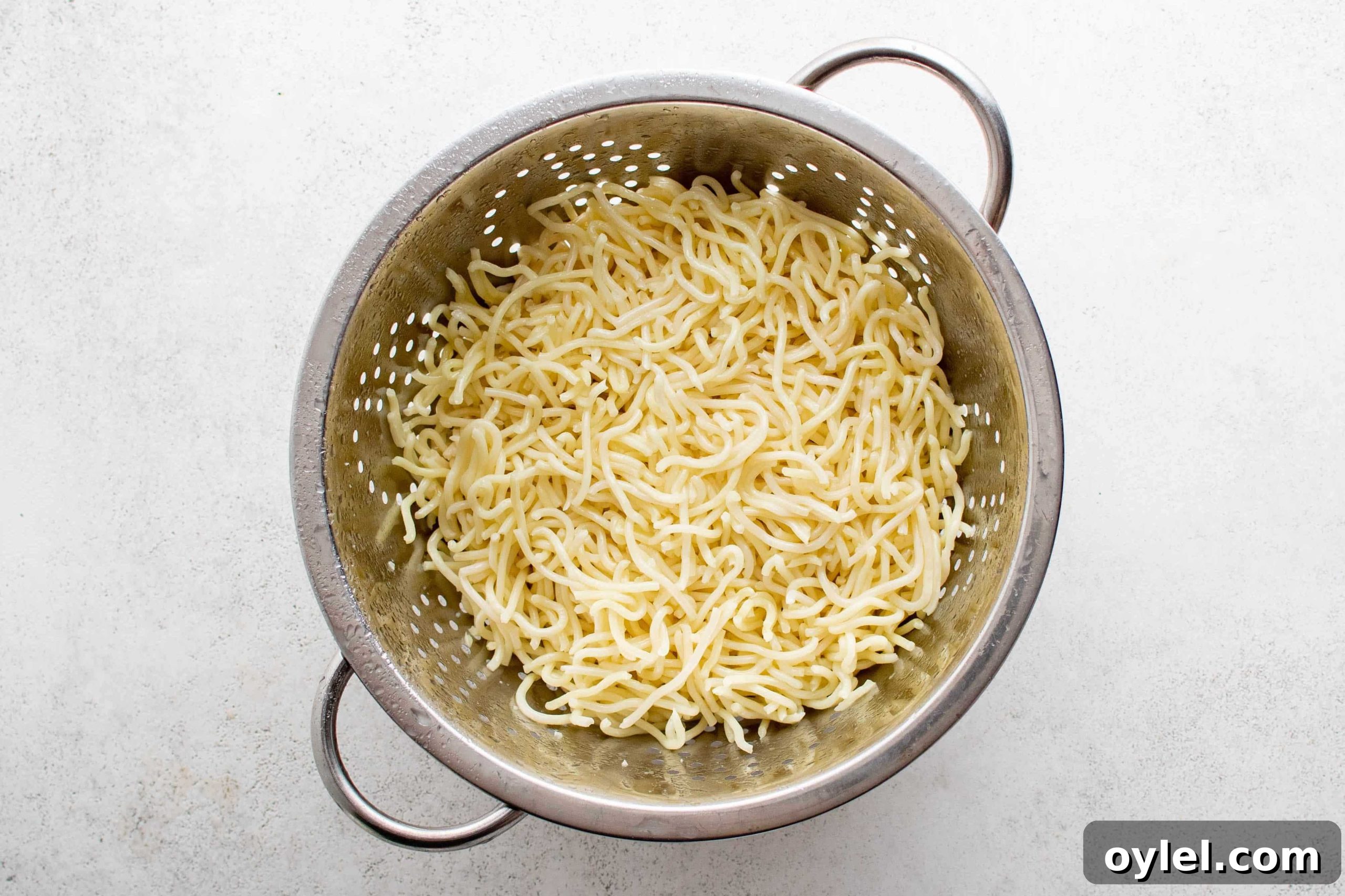 Rinsed yaki soba noodles in a large colander.