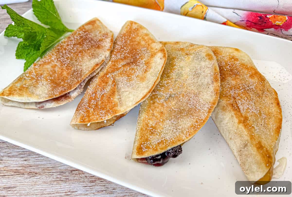 Four pieces of Fruit Quesadillas on a white plate.