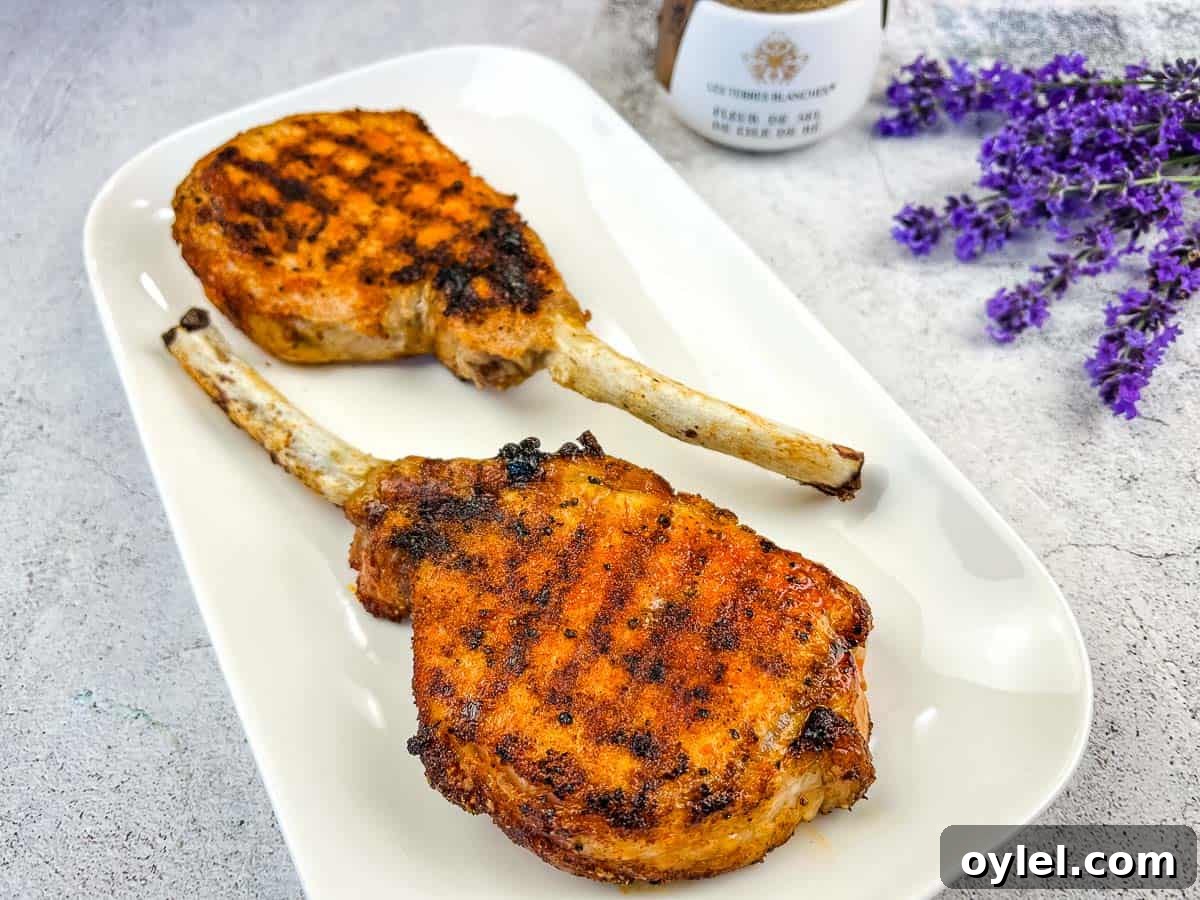 Ninja Grilled Tomahawk Pork Chops on a white plate.