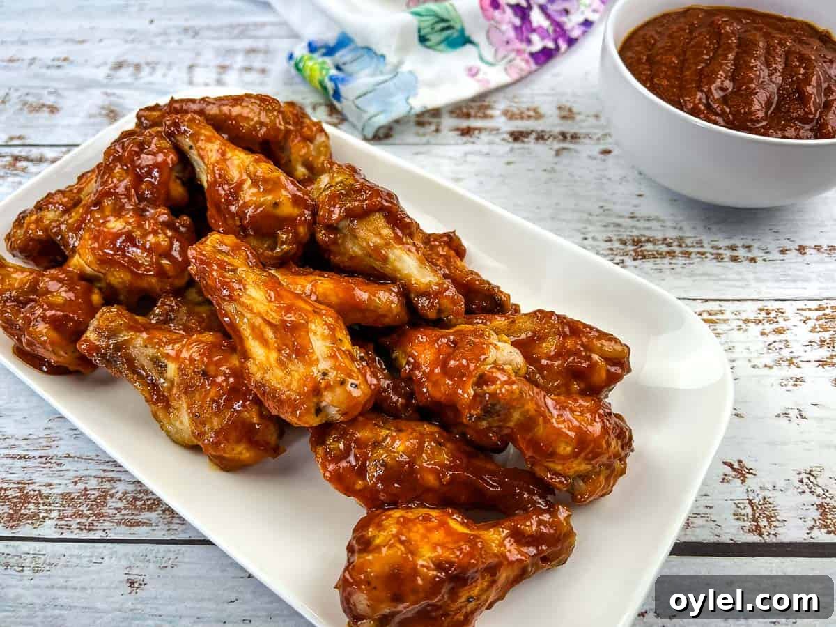 Ninja Woodfire Grill Wings with Jack Daniel's BBQ Sauce on a white plate.
