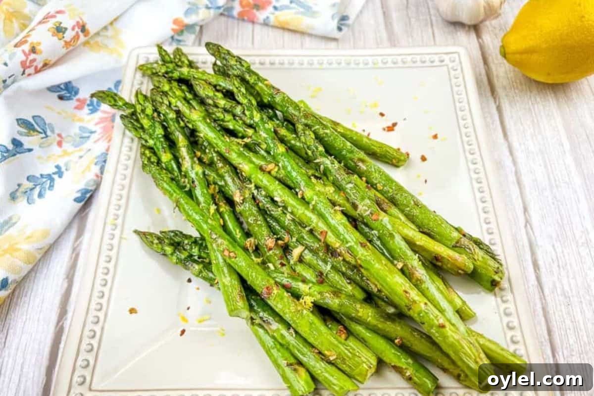 Grilled Asparagus on a white square plate.