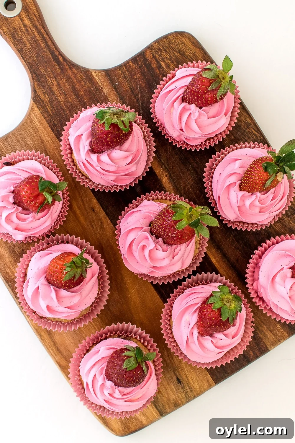 Low carb and keto friendly Strawberry cupcake muffins with ruffled pink frosting.