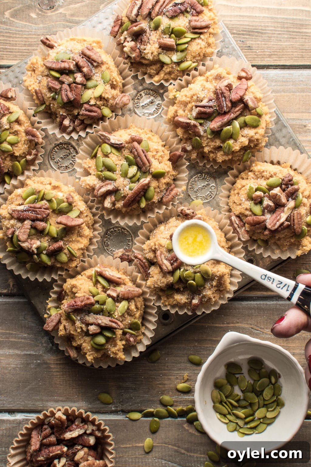 Low-carb pumpkin spice muffins topped with pecans and pumpkin seeds.