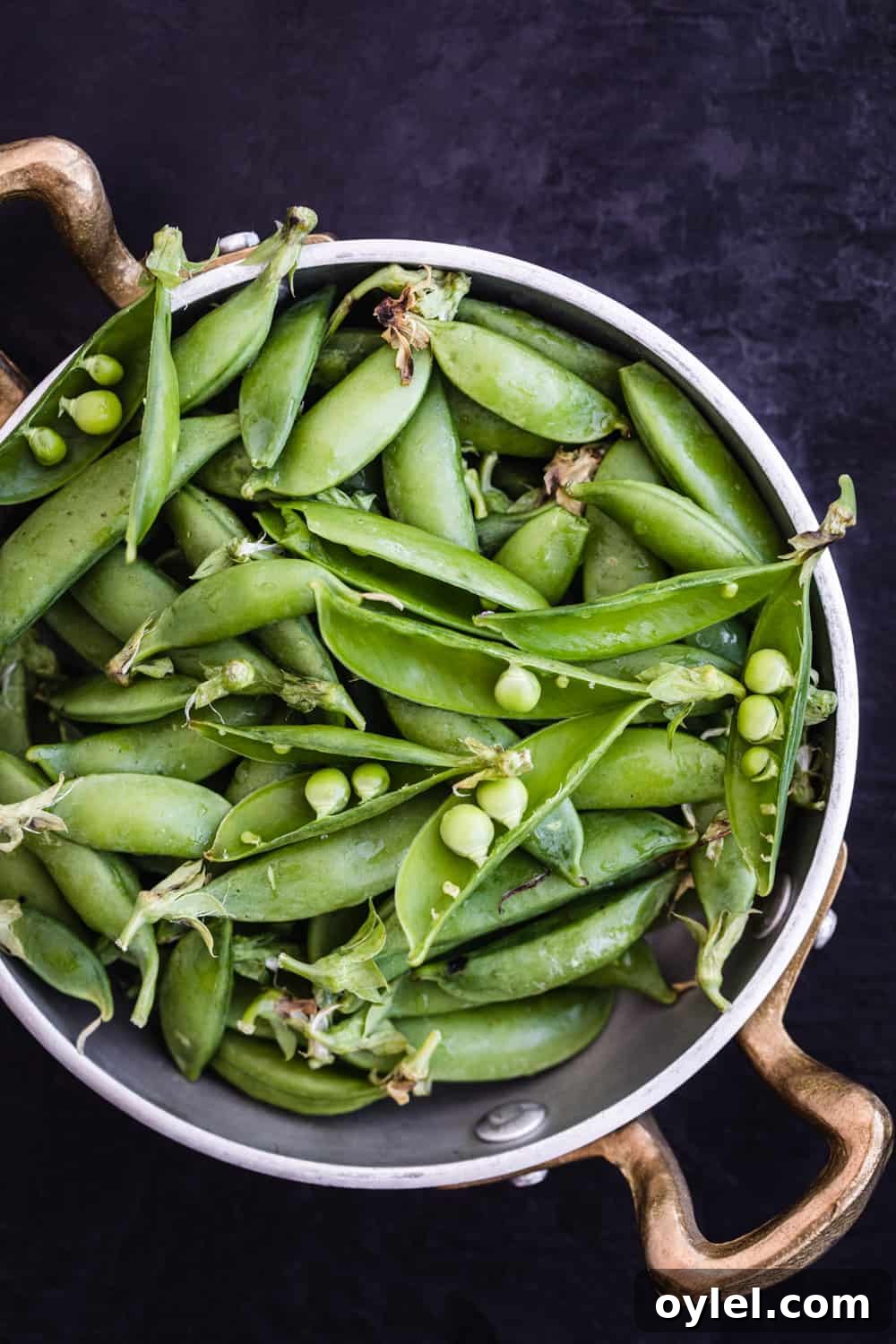 Spring Pea and Carrot Salad with Carrot Top Pesto 5 Snap peas in a silver bowl.