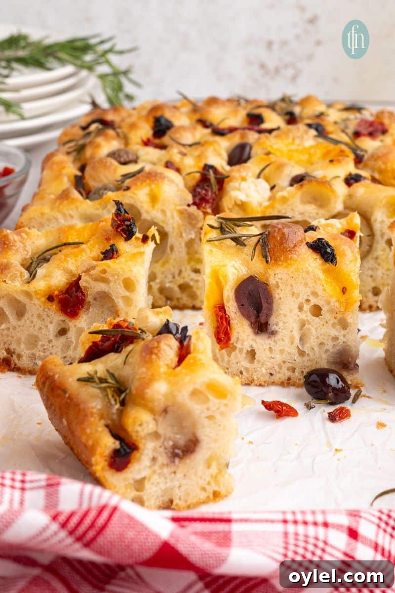 Sourdough Focaccia Recipe: Crispy Crust, Airy Interior 3 Sliced focaccia on a pan.