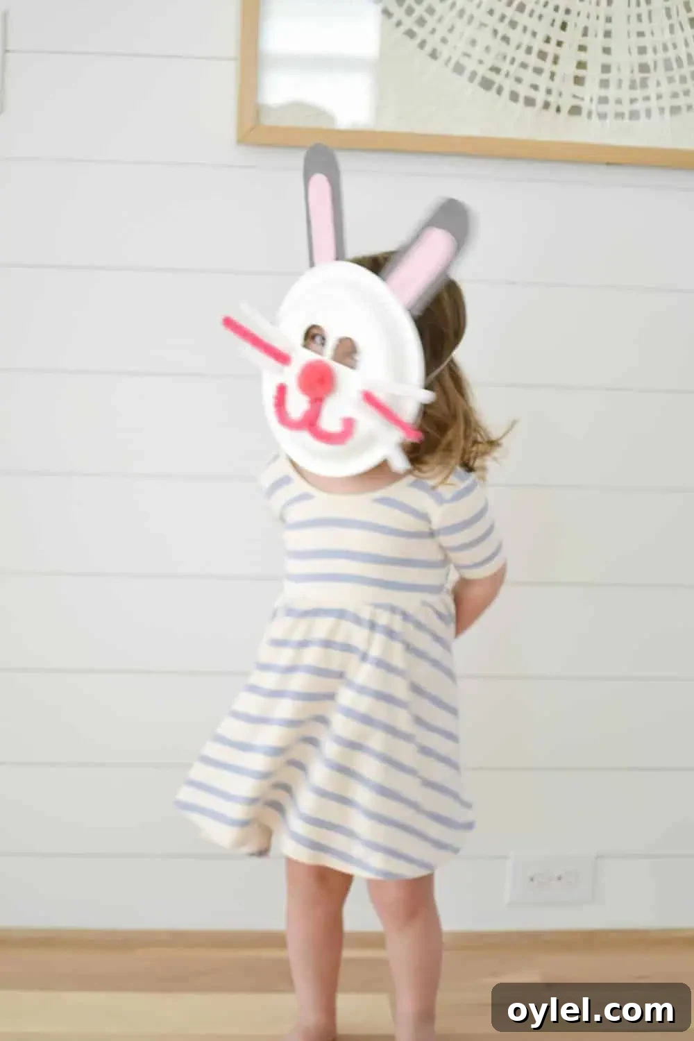 DIY Easter Bunny Masks for Kids: Printable No-Sew Templates 9 a little girl wearing an easter bunny mask