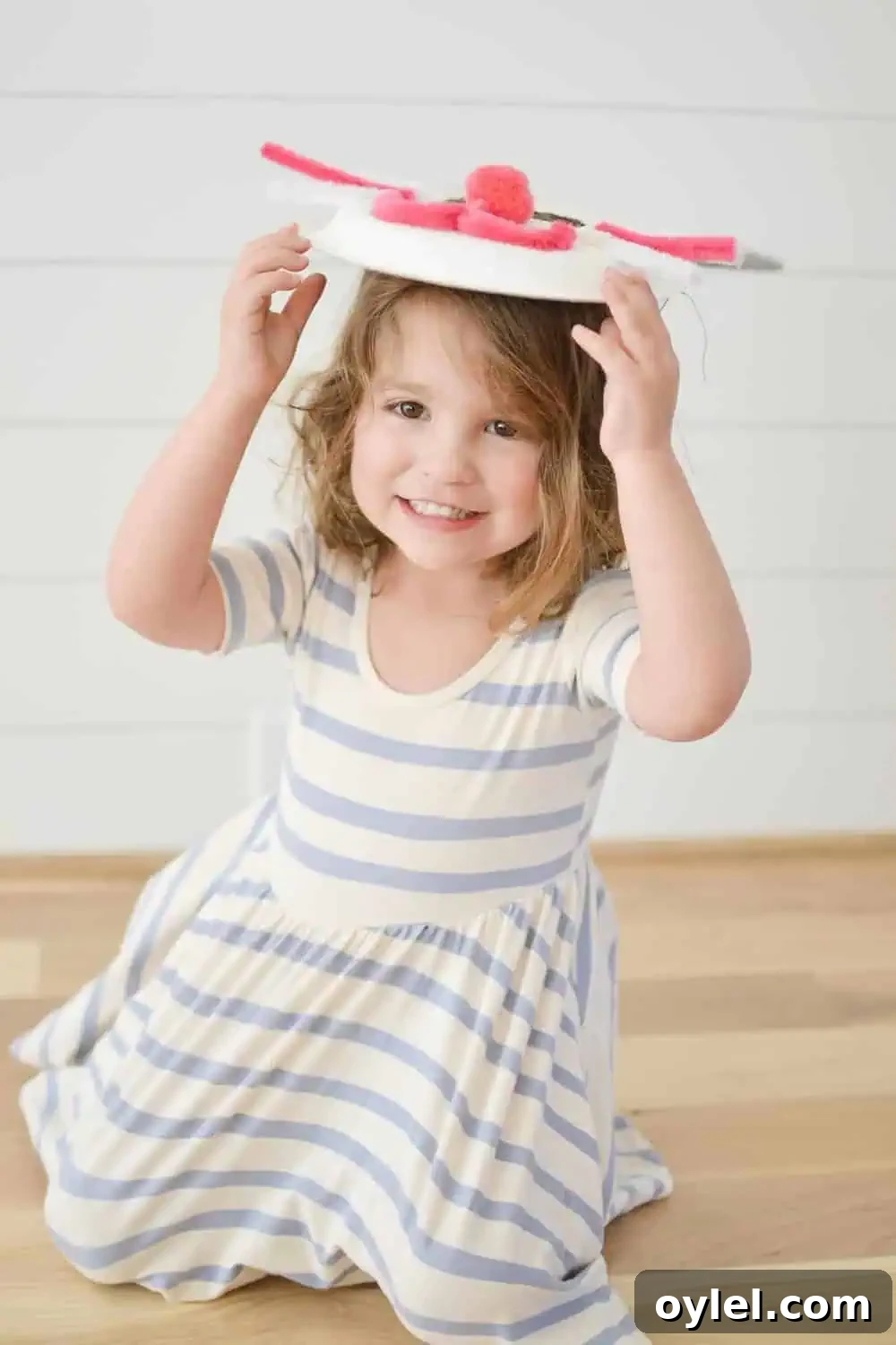 DIY Easter Bunny Masks for Kids: Printable No-Sew Templates 2 a little girl smiling and holding up her mask