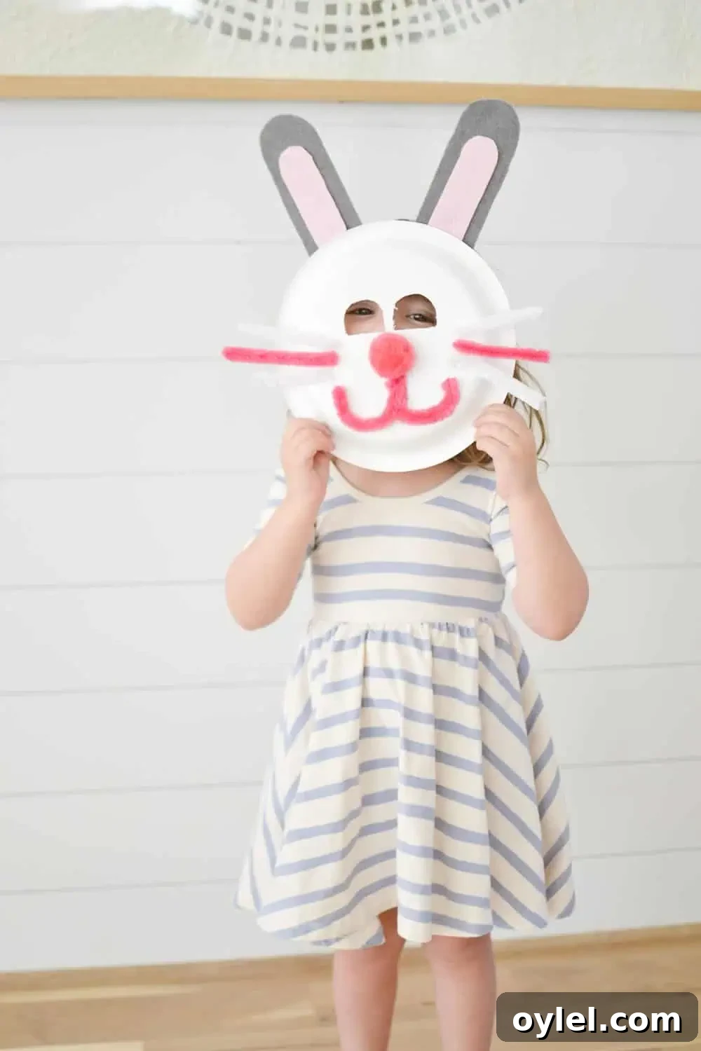 DIY Easter Bunny Masks for Kids: Printable No-Sew Templates 4 toddler in a dress with an easter bunny mask made out of a paper plate