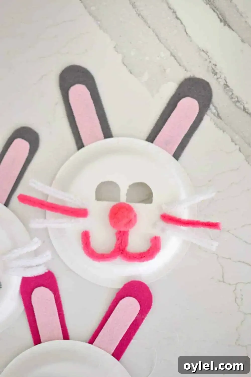 DIY Easter Bunny Masks for Kids: Printable No-Sew Templates 5 1 pink and white easter bunny mask made out of a paper plate