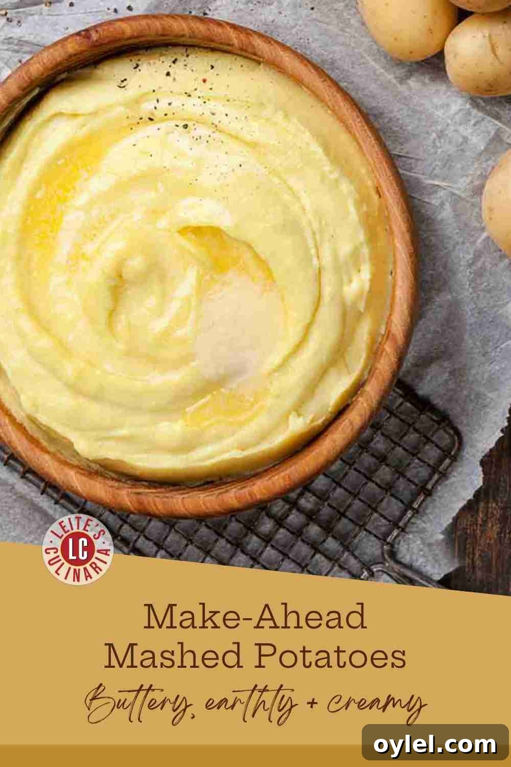 Creamy, smooth mashed potatoes topped with melted butter, salt, and pepper in a wooden bowl.