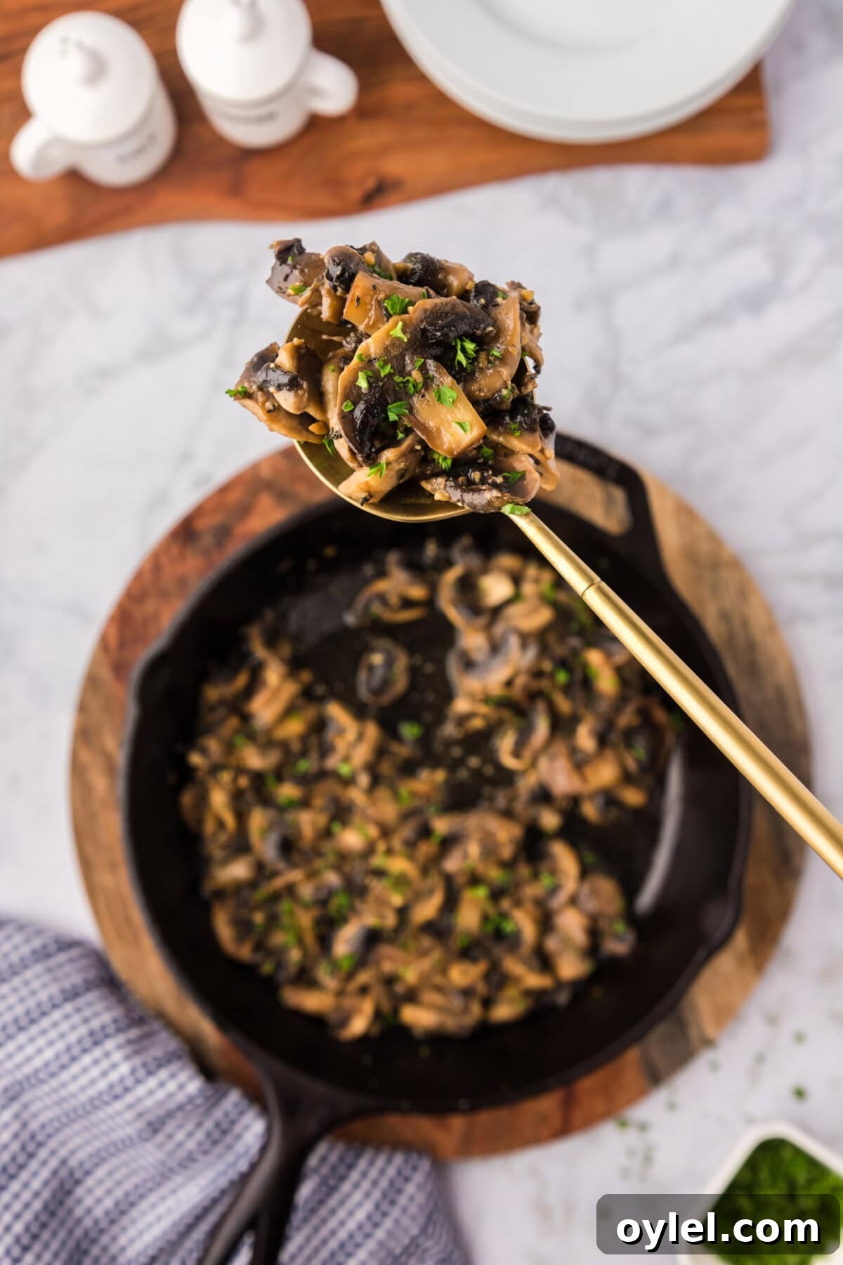 Sauteed Mushrooms with Garlic and Thyme Recipe 2 Spoonful of Sautéed Mushrooms held over a skillet