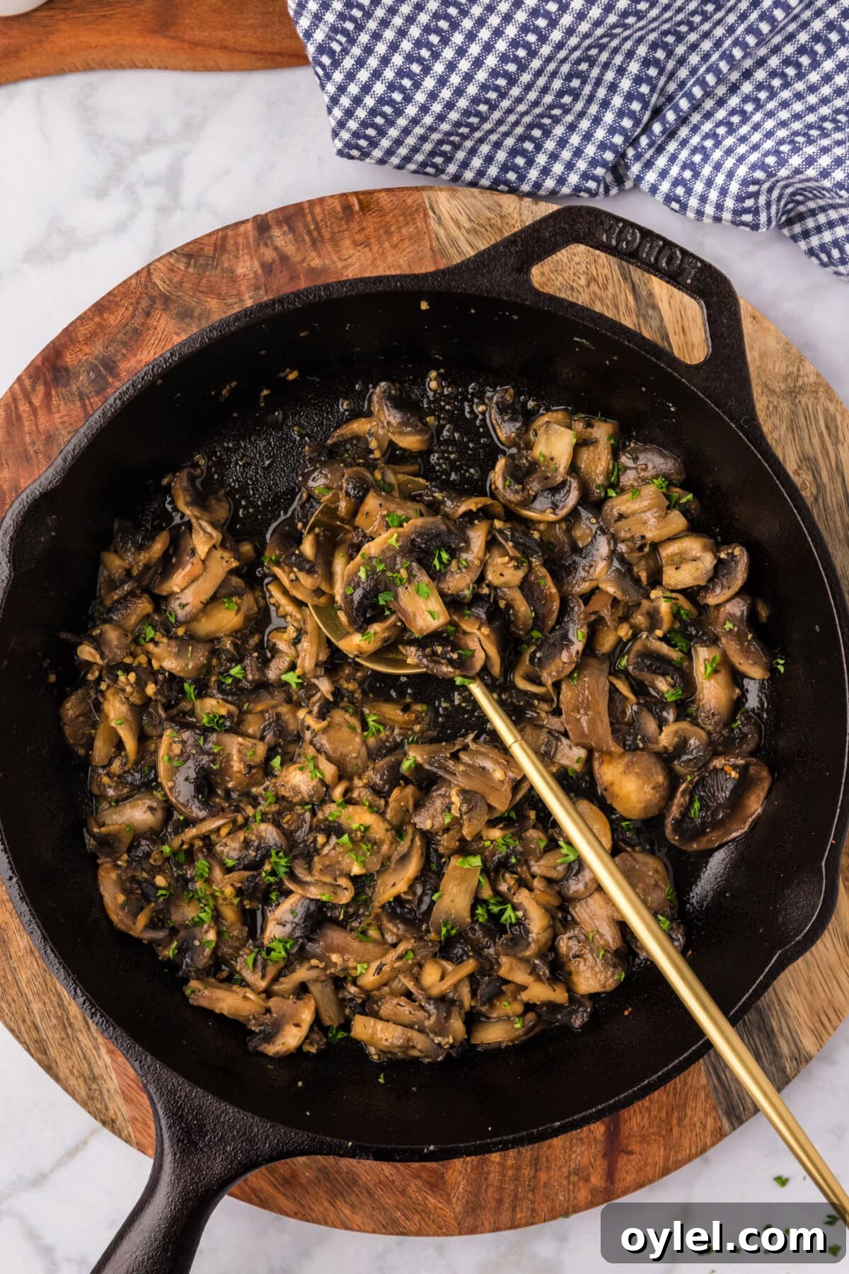 Sauteed Mushrooms with Garlic and Thyme Recipe 3 Skillet of Sautéed Mushrooms with a spoon