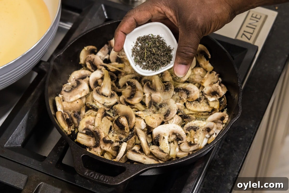 Sauteed Mushrooms with Garlic and Thyme Recipe 7 adding thyme leaves to skillet with mushrooms