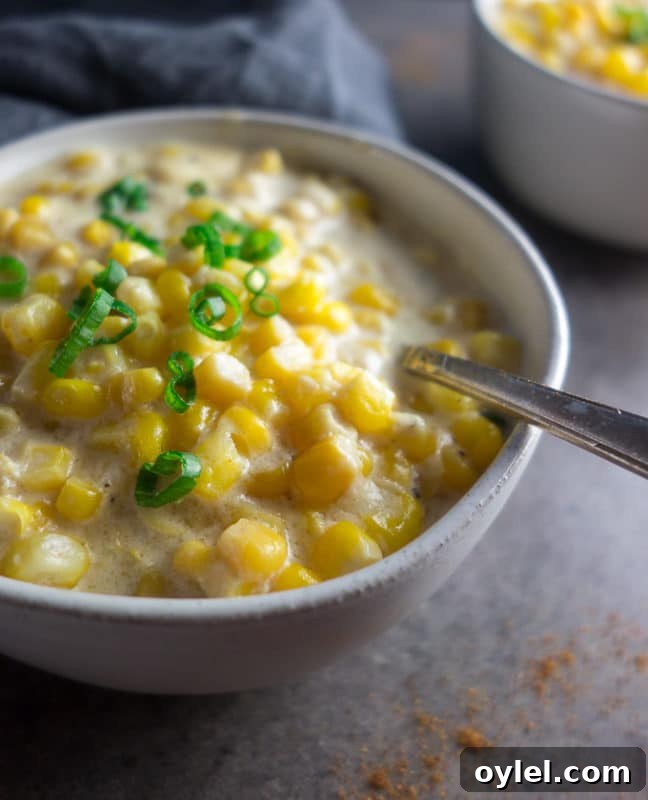 Bowl containing Spicy Creamed Corn made in Instant Pot, topped with scallions.