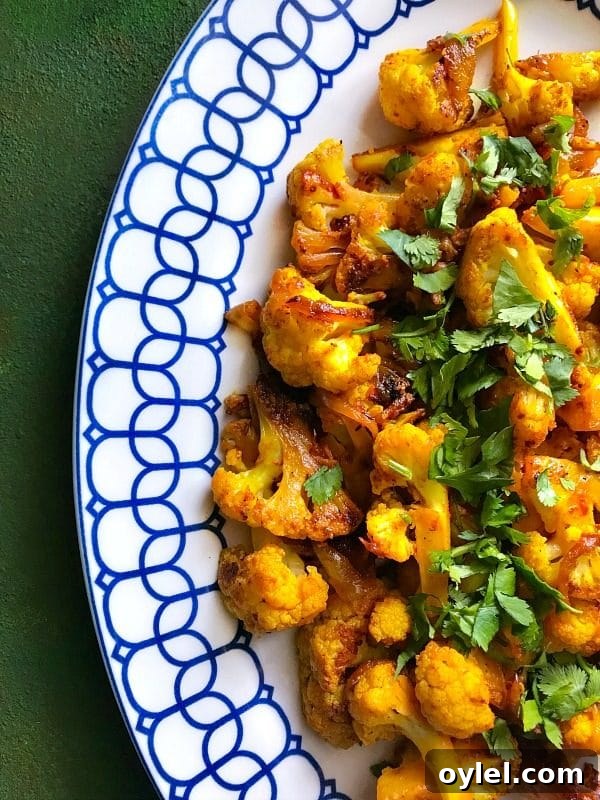 Blue and white plate containing Cauliflower mixed with Indian Spices made in an Instant Pot.