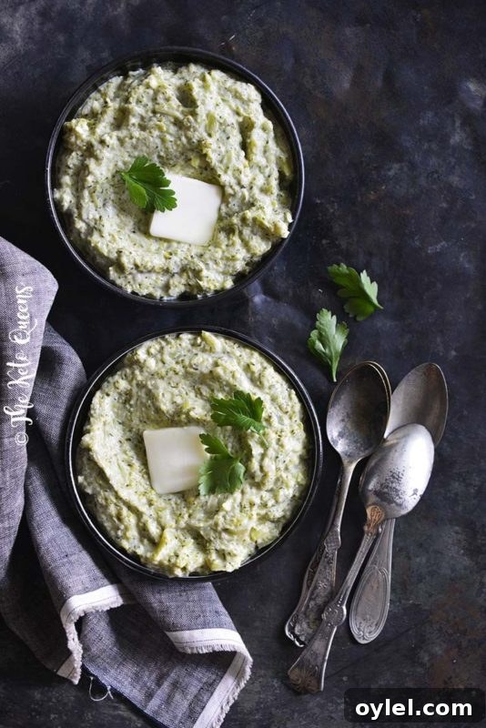 2 black bowls containing a Creamy Garlic Broccoli Mash made in an instant Pot, topped with butter and cilantro.