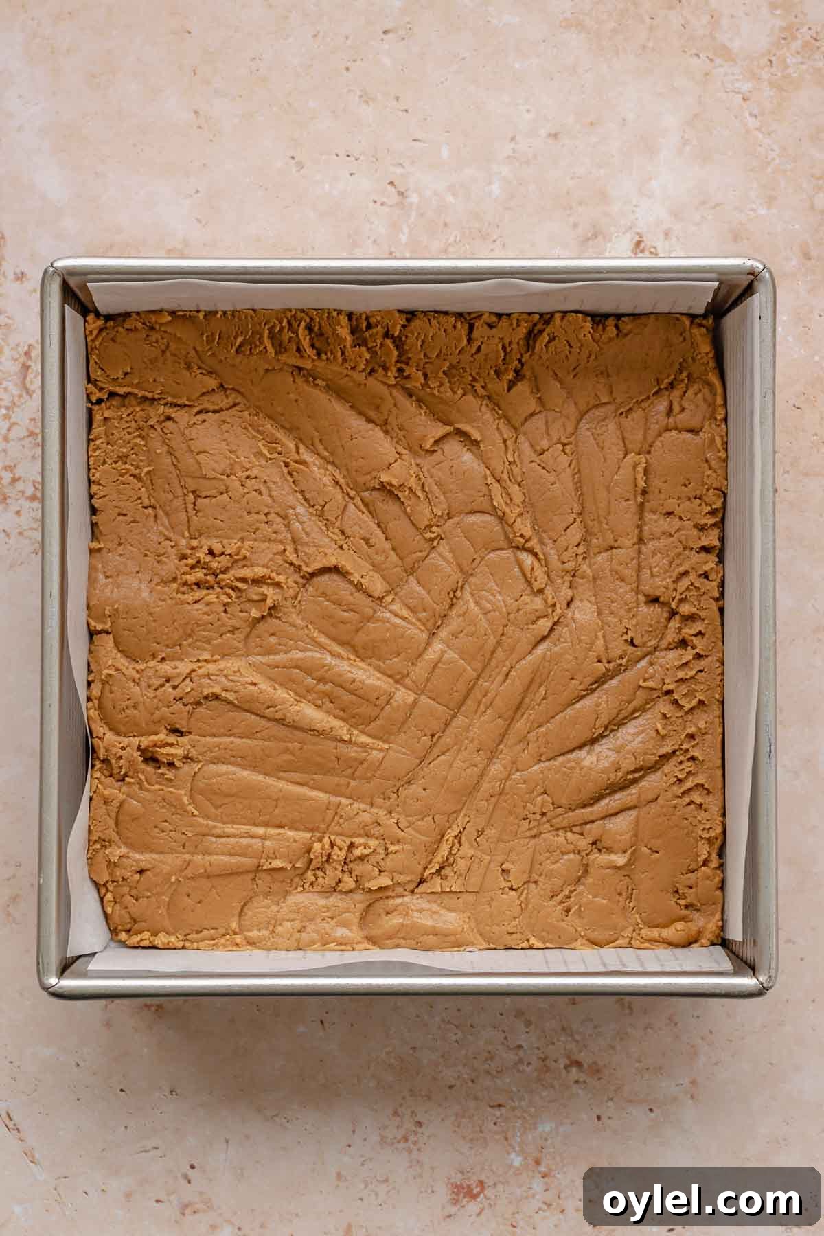 Cookie butter fudge pressed into a pan.
