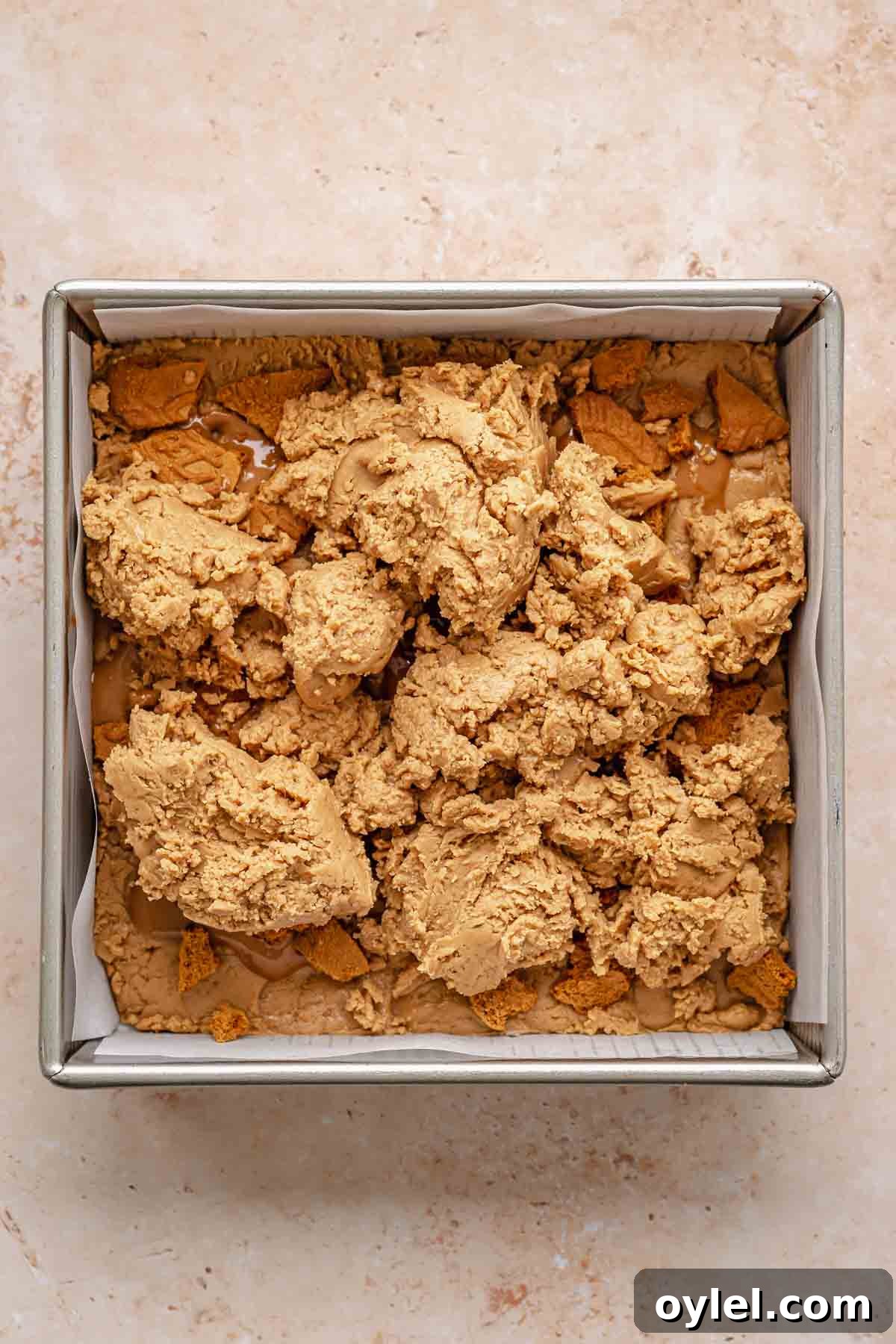 Biscoff fudge in a pan before being smoothed out.